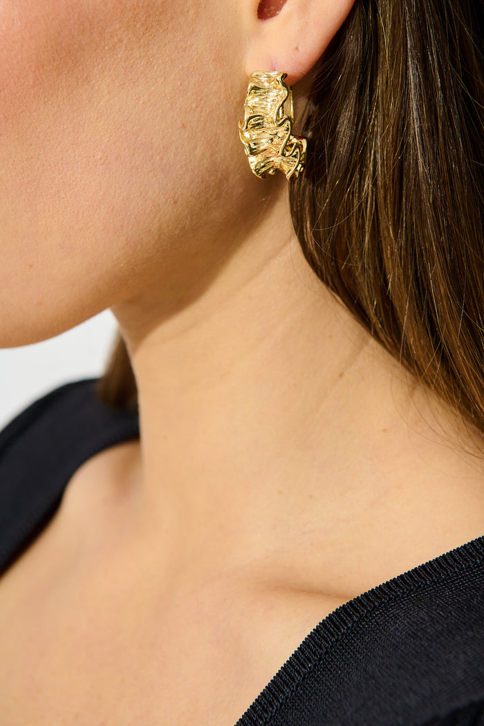 Selena Hoop Earrings in 18K Textured Gold Plated on model side cropped