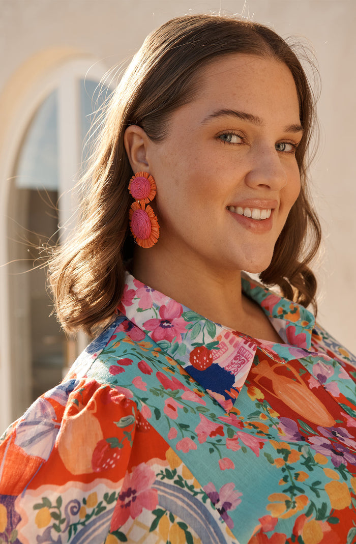 Poppy Earrings in Fuchsia and Tangerine Raffia campaign on model side