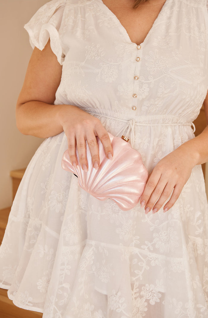 Colette Shell Clutch in Pearlescent Pink campaign on model front