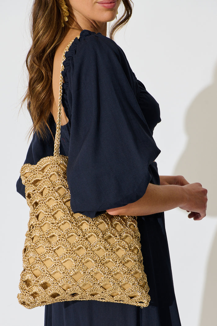 Sienna Tote Bag in Natural Gold Straw with Scallop Texture on model side close up