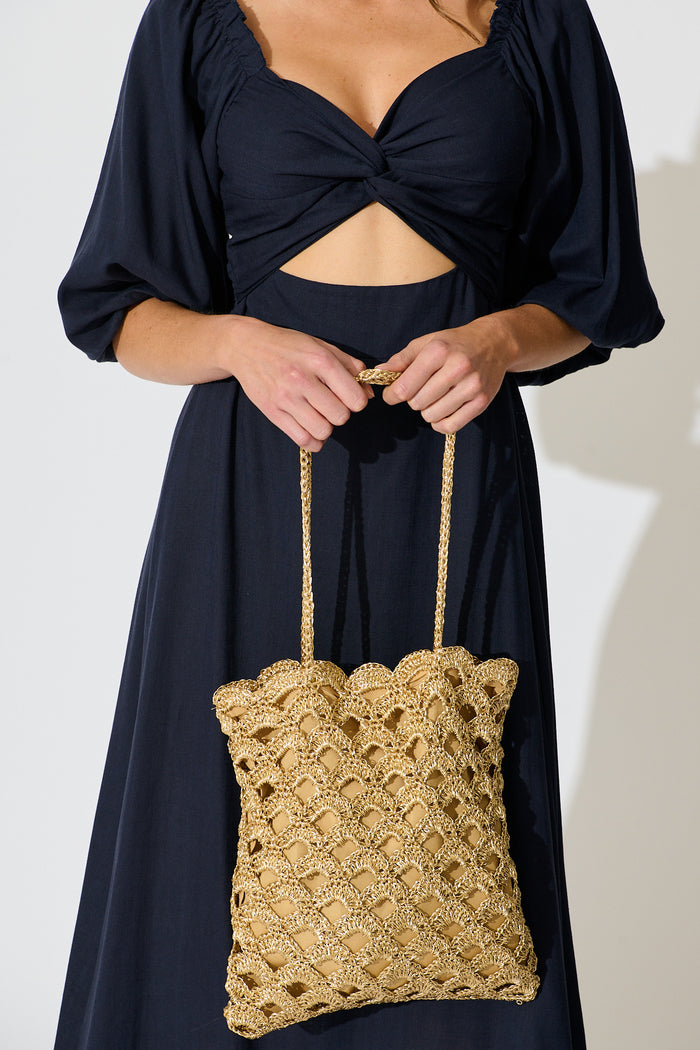 Sienna Tote Bag in Natural Gold Straw with Scallop Texture on model front