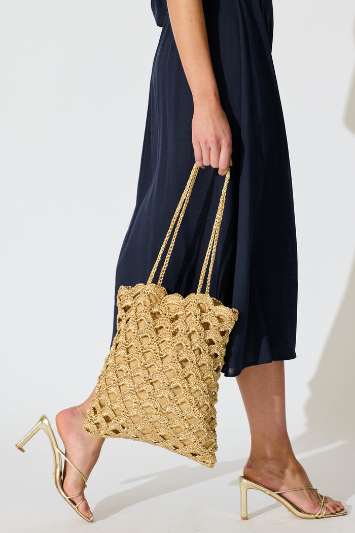Sienna Tote Bag in Natural Gold Straw with Scallop Texture on model side