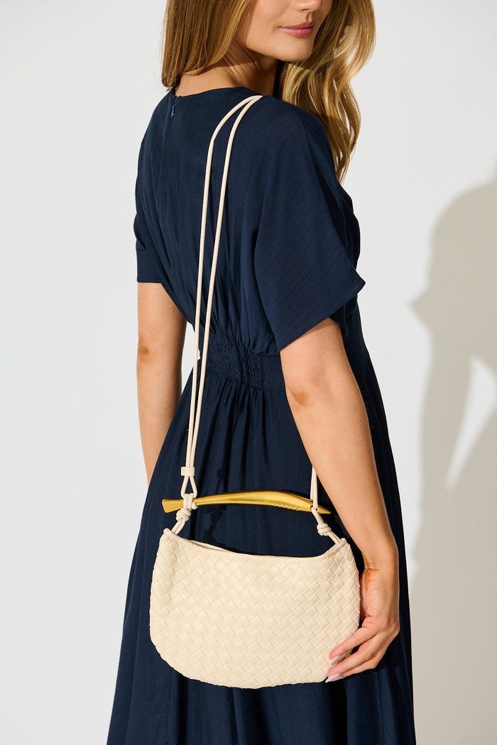 Chloe Quilted Multiway Bag in Cream with Gold Bar Handle on model crossbody