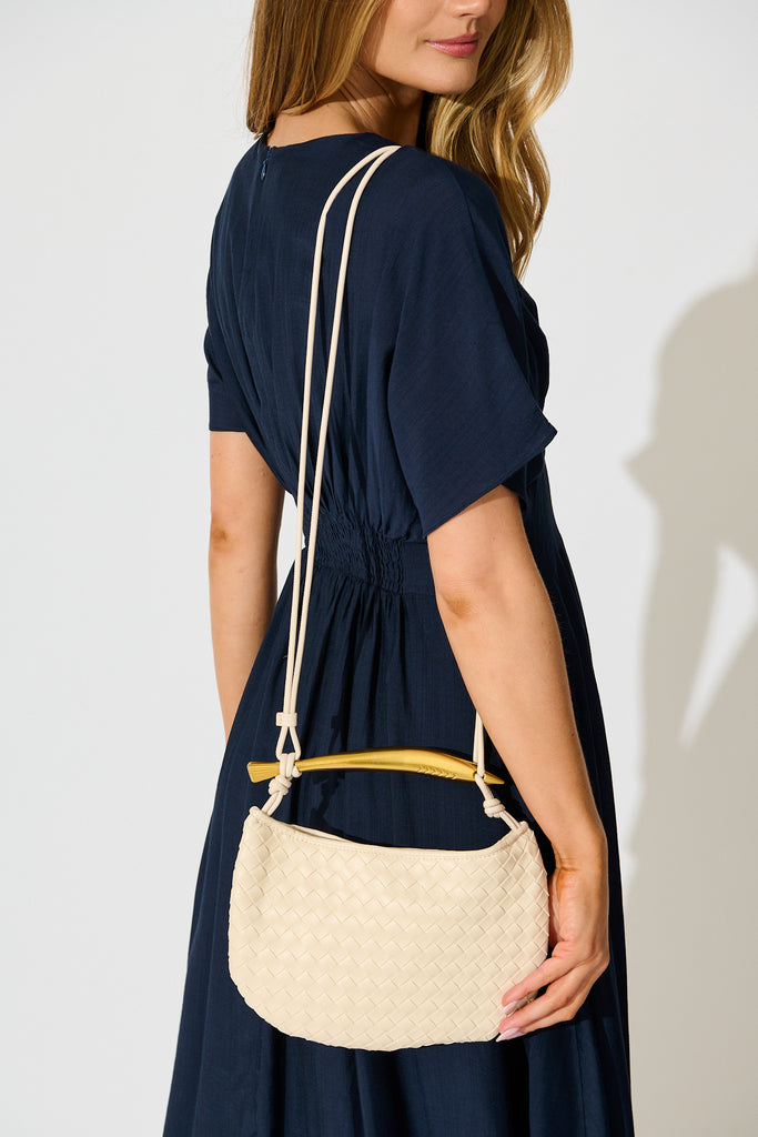 Chloe Quilted Multiway Bag in Cream with Gold Bar Handle on model crossbody