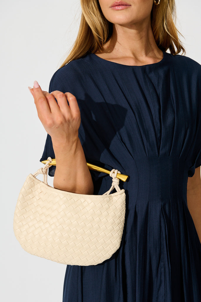 Chloe Quilted Multiway Bag in Cream with Gold Bar Handle on model front