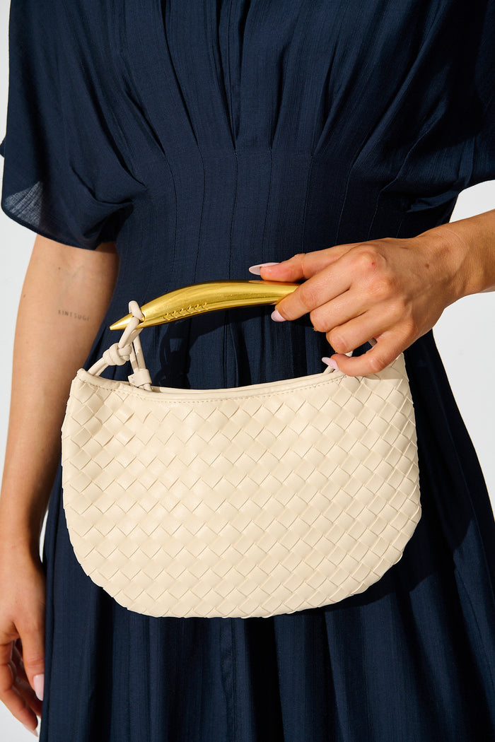 Chloe Quilted Multiway Bag in Cream with Gold Bar Handle on model front close up