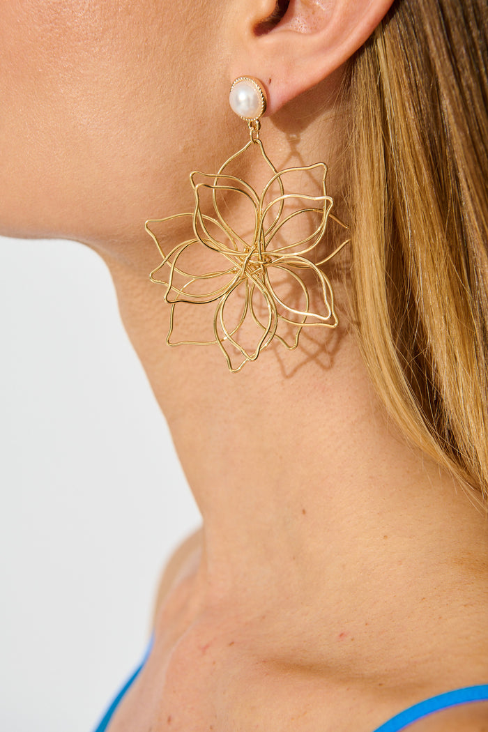 Costa Floral Drop Earrings in Gold with Pearl on model side close up