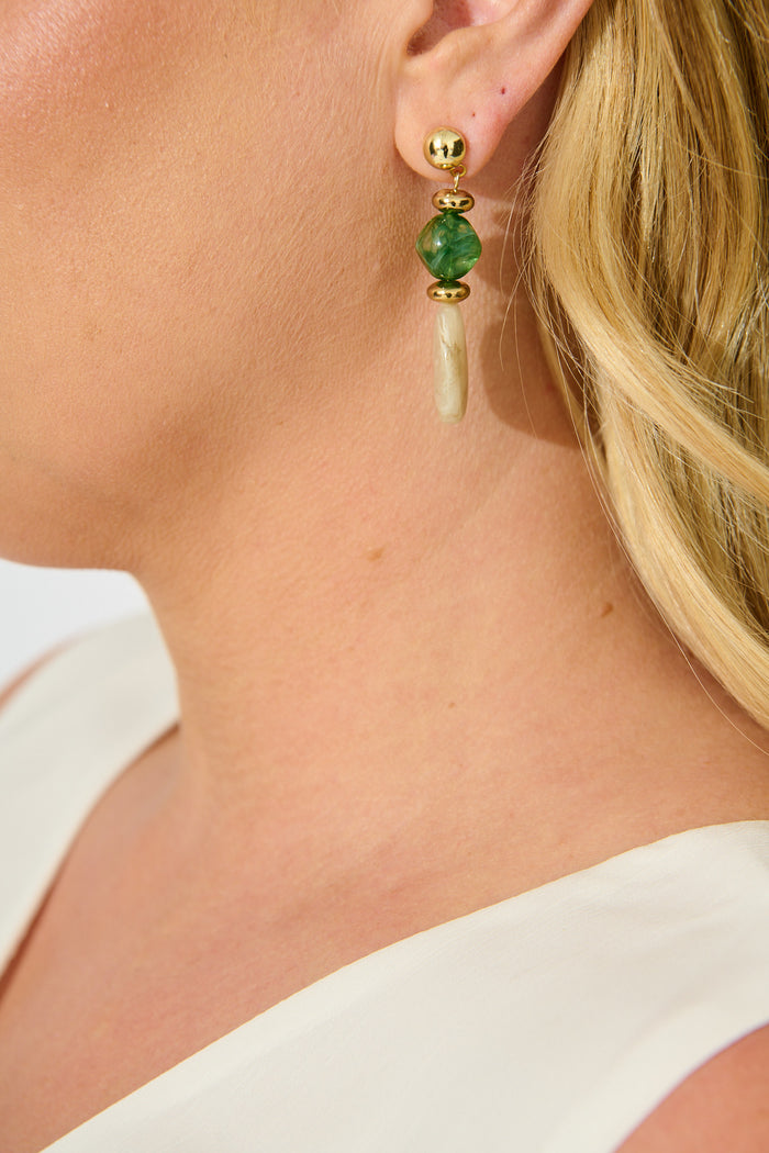 Zara Drop Earrings in Jade Green and Champagne Resin on model close up