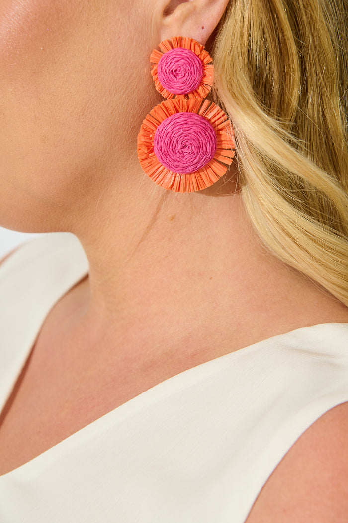 Poppy Earrings in Fuchsia and Tangerine Raffia on model close up