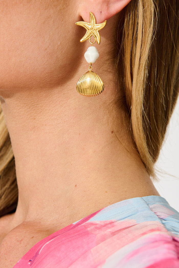 Starfish Embellished Drop Earrings in Gold on model side close up