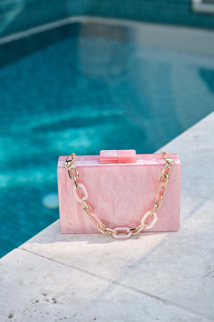 Candice Clutch in Pearlescent Pink campaign flatlay