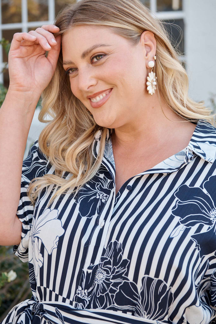 Flora Drop Earrings in White and Gold Daisy Raffia campaign on model side