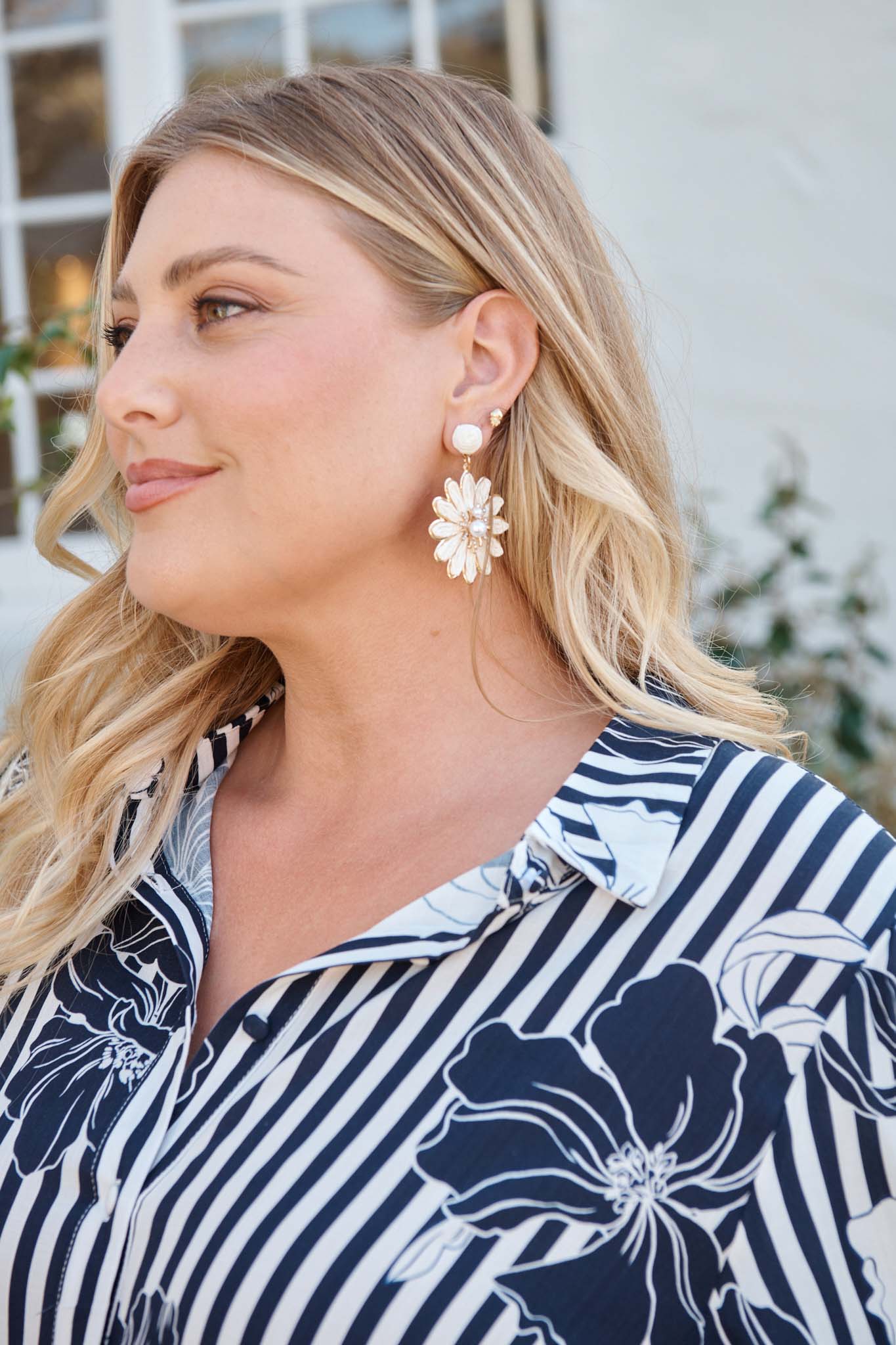 Flora Drop Earrings in White and Gold Daisy Raffia campaign on model side