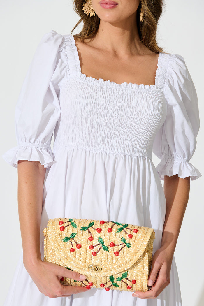 Clara Cherry Embroidered Straw Crossbody Bag in Natural on model front