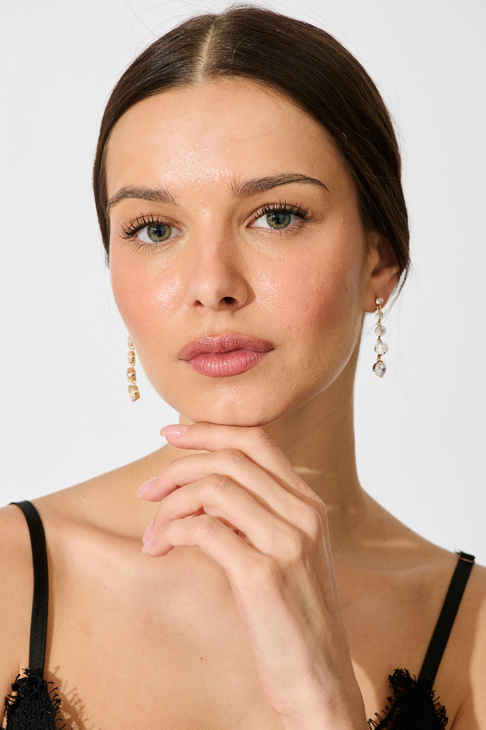 Carlene Drop Earrings in Gold Cubic Zirconia on model front
