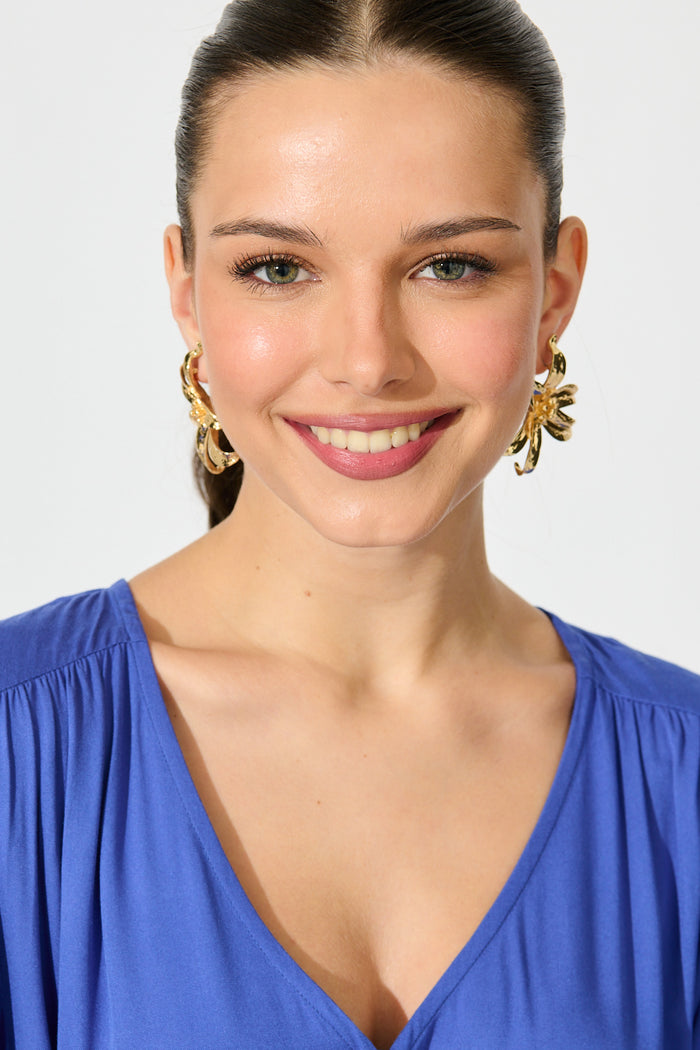 Lianne Lily Stud Earrings in Gold on model front
