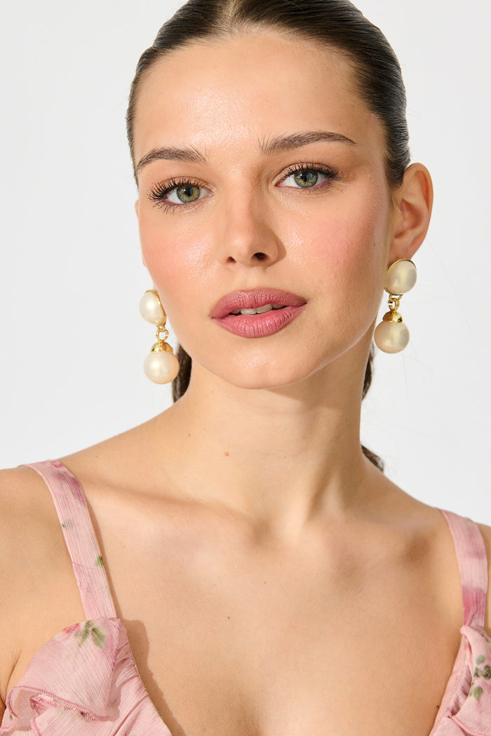 Carla Drop Earrings in Gold with Pearl on model front