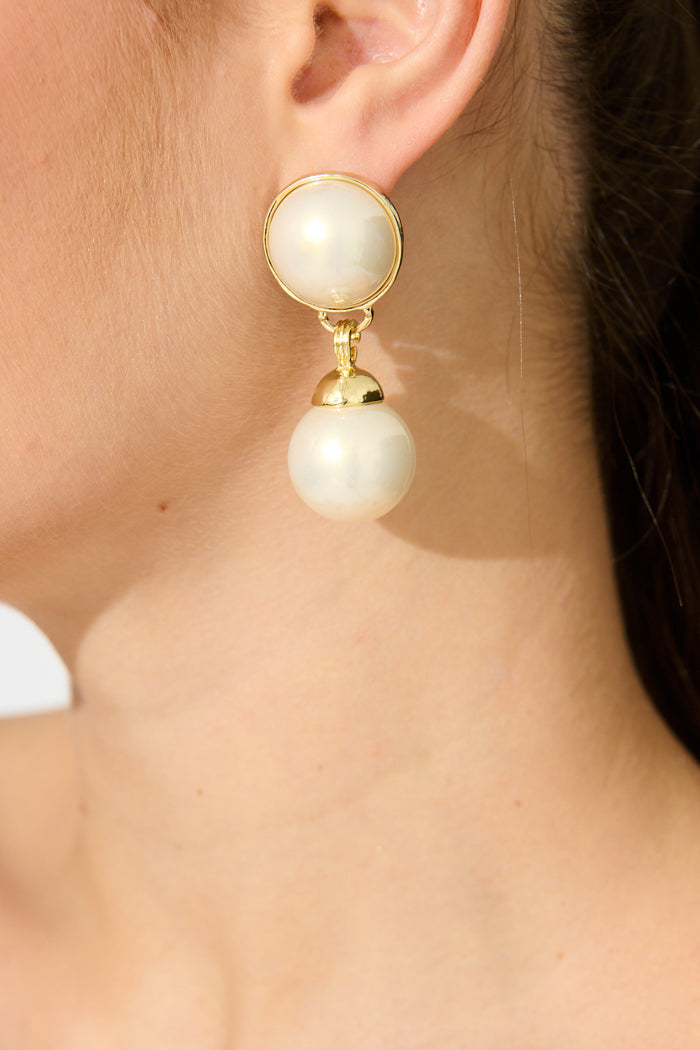 Carla Drop Earrings in Gold with Pearl on model close up