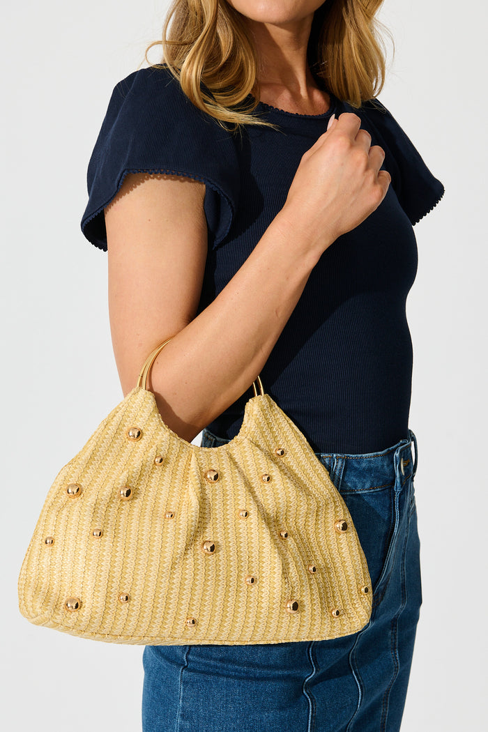 Siena Raffia Circle Handle Bag in Natural with Gold on model side