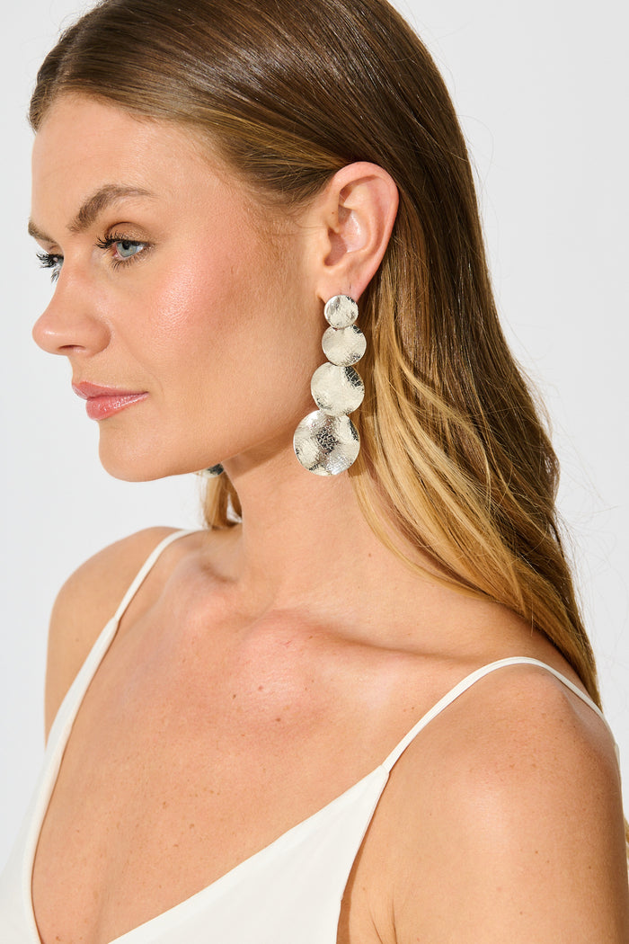 Alma Drop Earrings in Silver Textured on model side