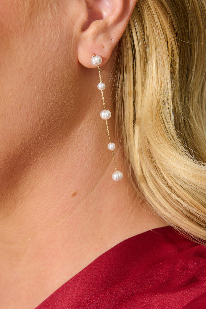 Yvette Drop Earrings in Gold with Pearl on model close up