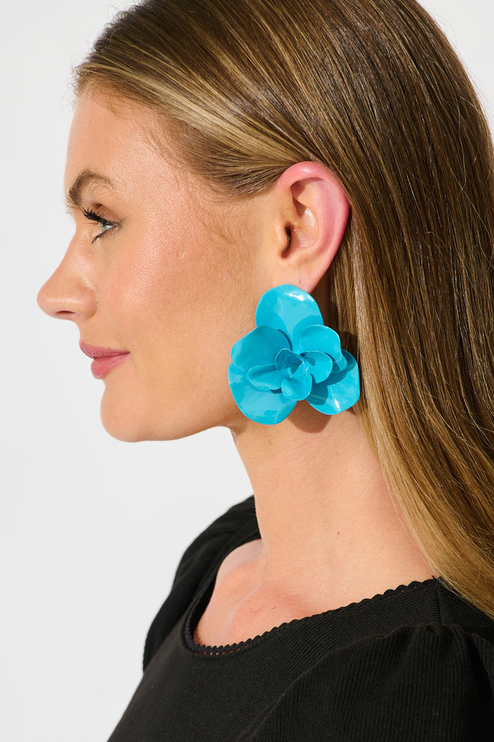 Ivy Floral Stud Earrings in Blue Resin on model side