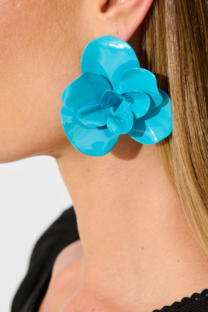 Ivy Floral Stud Earrings in Blue Resin on model close up
