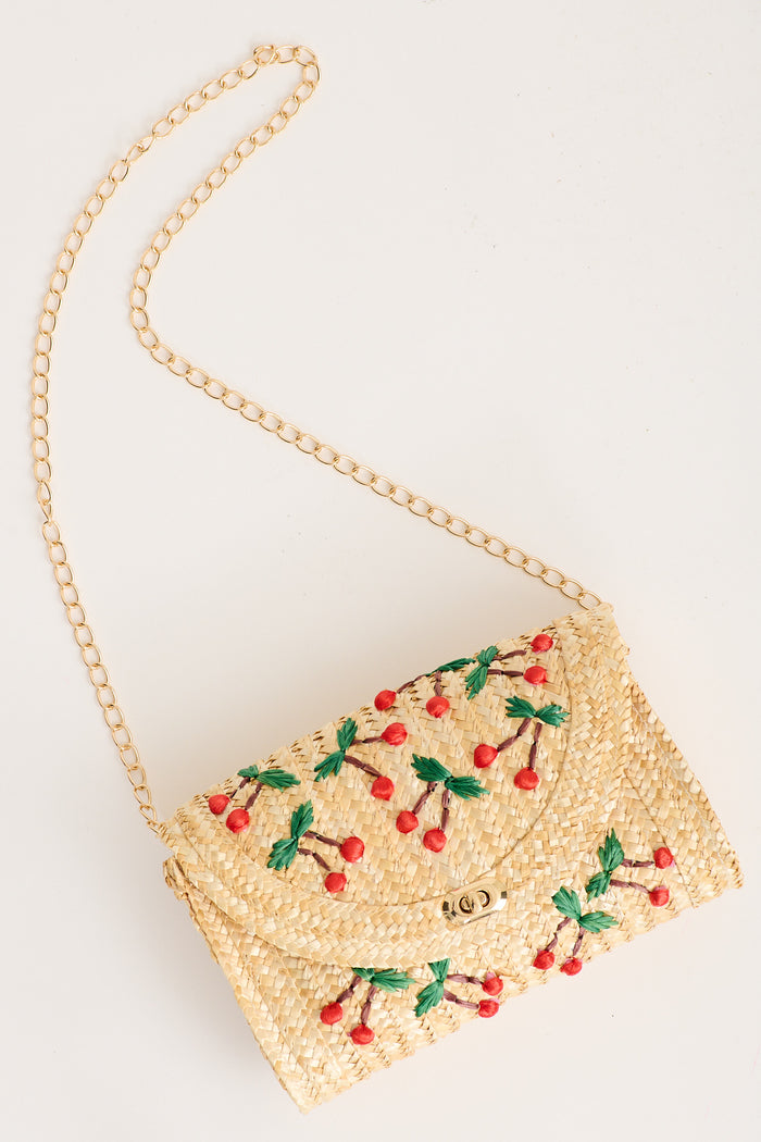 Clara Cherry Embroidered Straw Crossbody Bag in Natural flatlay strap