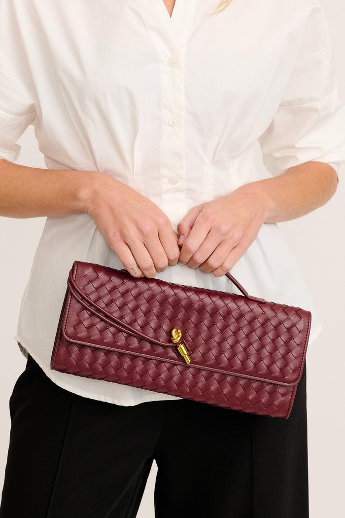 Juliette East West Woven Clutch Bag in Burgundy on model front