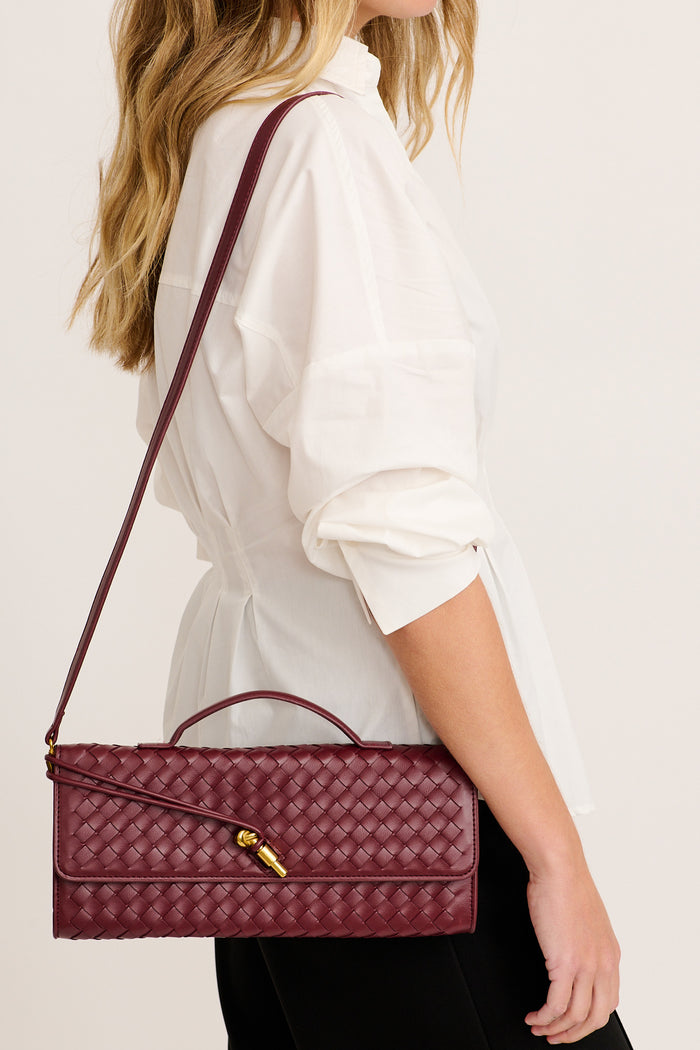 Juliette East West Woven Clutch Bag in Burgundy on model sling