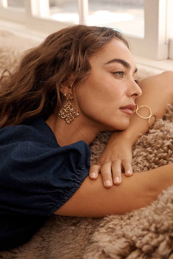 Cleo Filigree Statement Earrings in Antique Gold on model side