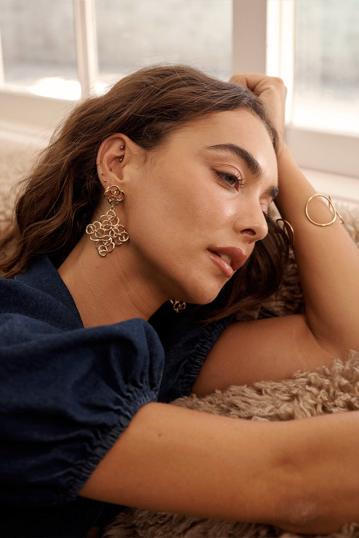 Cleo Filigree Statement Earrings in Antique Gold on model side
