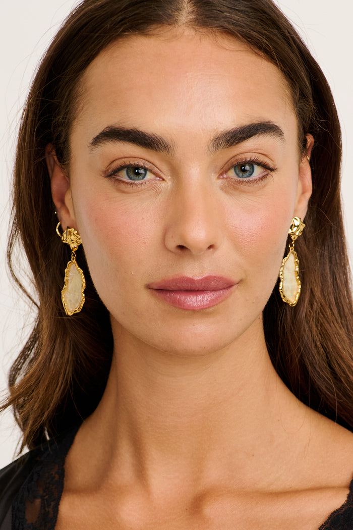 Ariana Stud Earrings in Gold Irregular Iridescent Stone on model front
