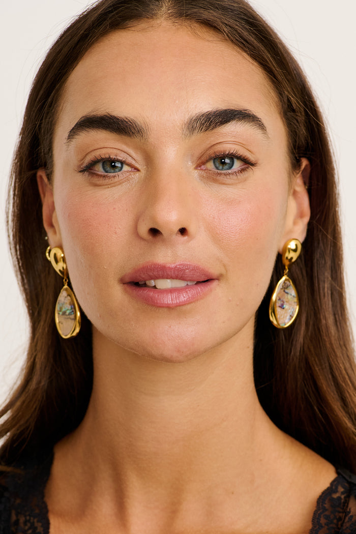 Svetlana Drop Earrings in Gold Teardrop Iridescent Stone on model front