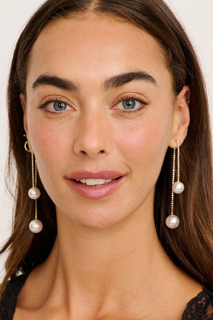 Vivian Pearl Drop Earrings in Gold Rhinestones on model front
