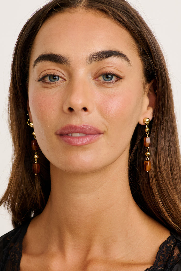 Alina Drop Earrings in Gold with Amber Resin on model front