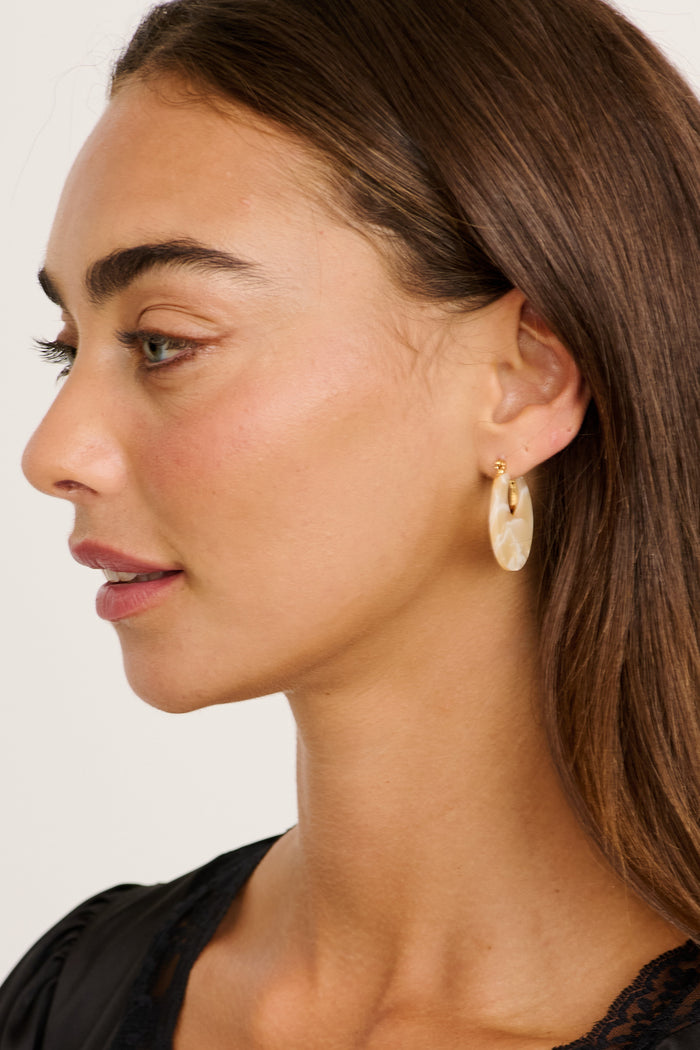 Talia Hoop Earrings in Gold with Cream Marble on model side