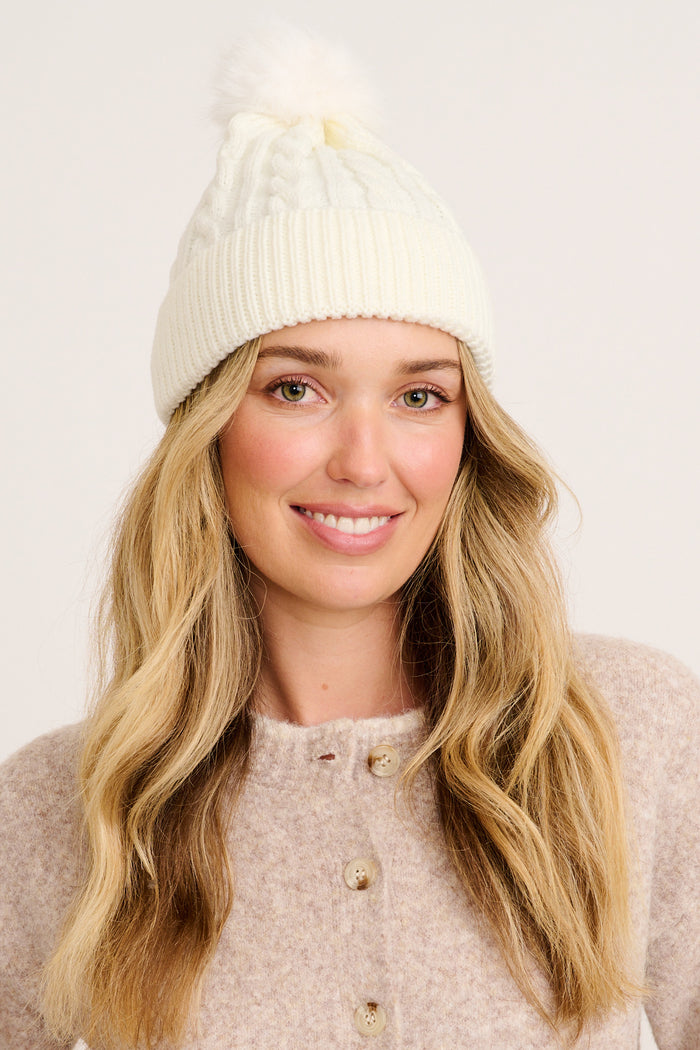 Tessa Cable Knit Beanie in Cream on model front