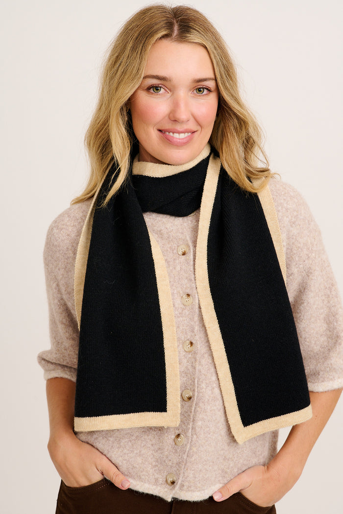 Noa Knit Scarf in Black with Beige Border on model front