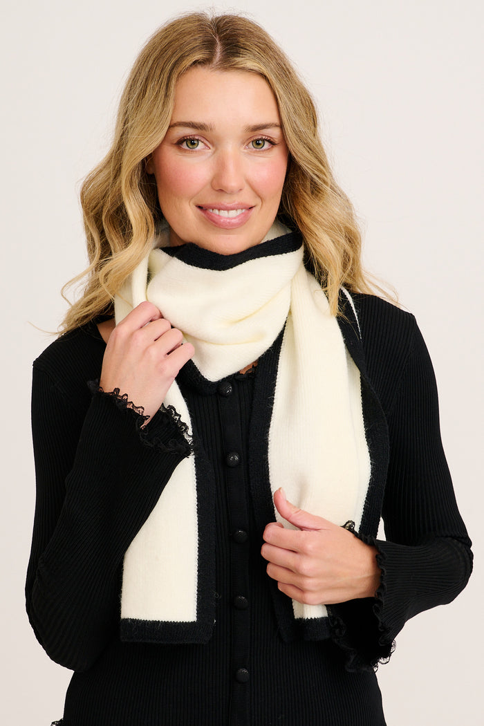 Noa Knit Scarf in White with Black Border on model front