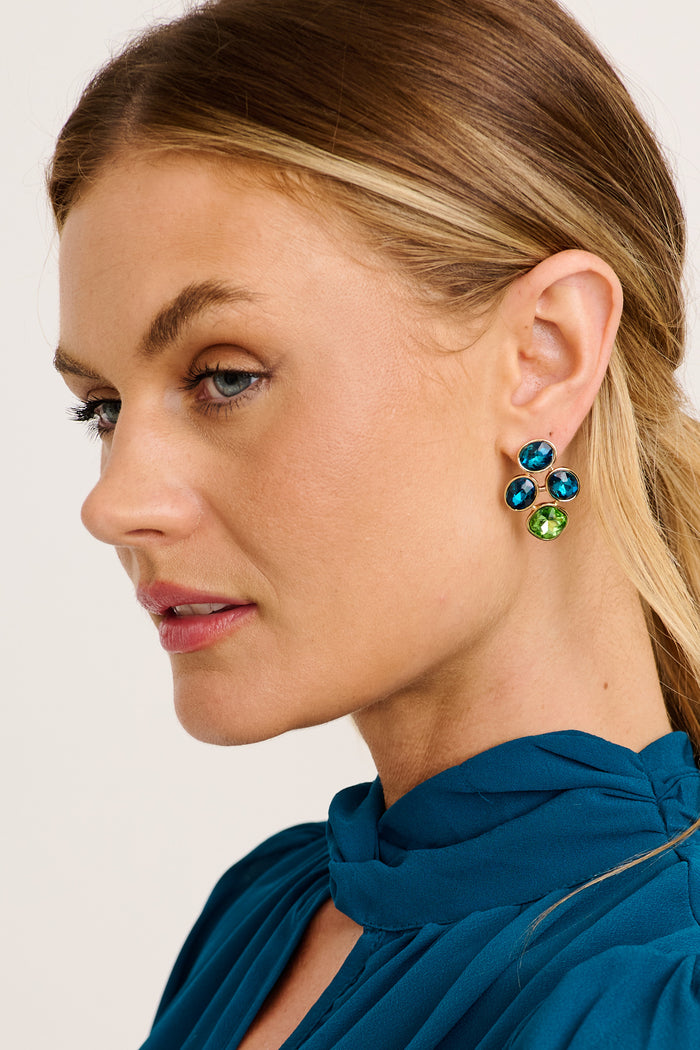 Zoya Stud Earrings in Multi Teal and Green Rhinestone on model side