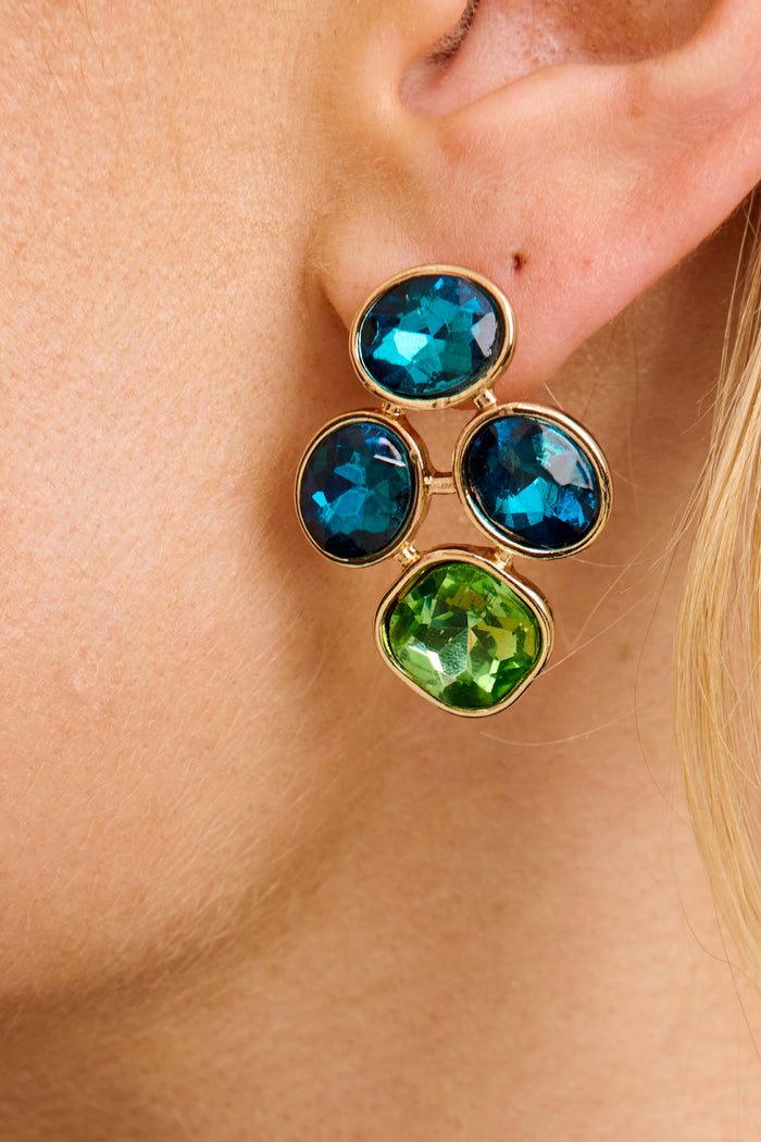Zoya Stud Earrings in Multi Teal and Green Rhinestone on model close up