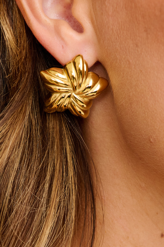 Veda Floral Stud Earrings in Textured Gold on model close up