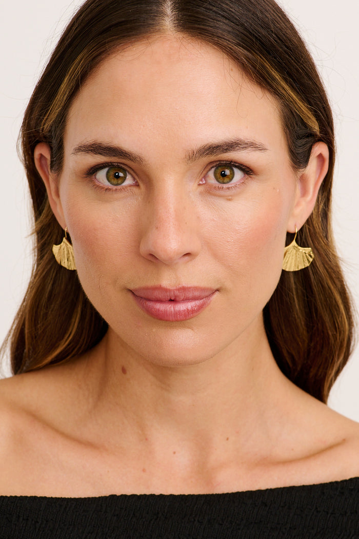 Naia Fan Drop Earrings in Gold Textured Statement on model front