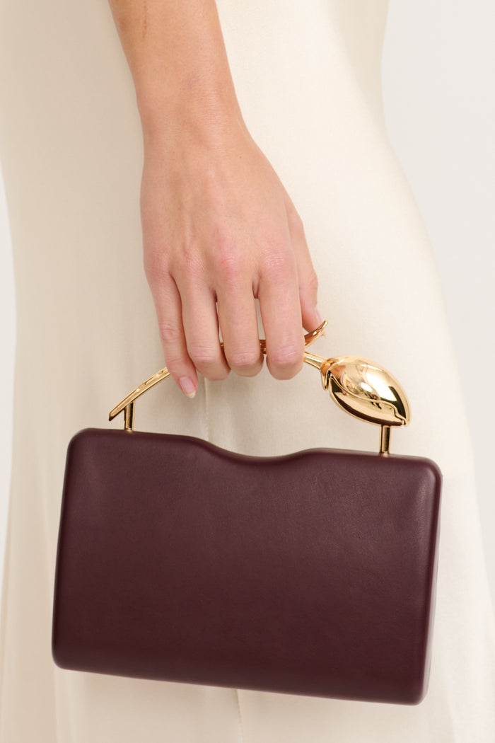 Elise Clutch bag in Wine on model side