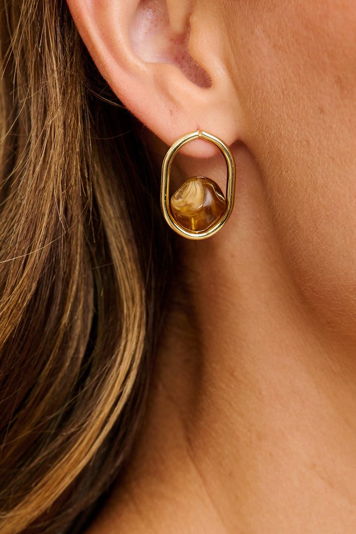 Sienna Resin Drop Earrings in Gold with Brown Resin on model close up