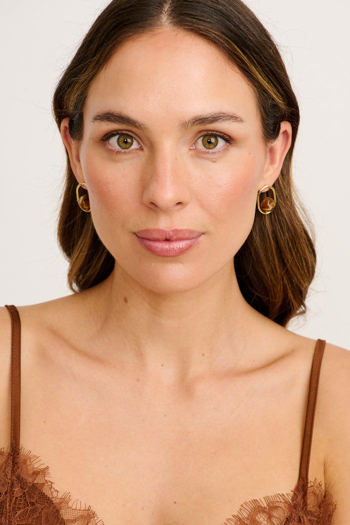 Sienna Resin Drop Earrings in Gold with Brown Resin on model front