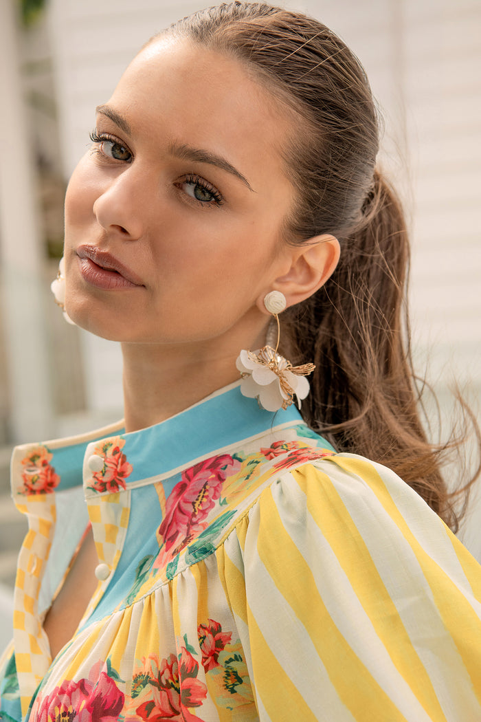 Camila Statement Earrings in Cream and Gold Floral campaign on model side