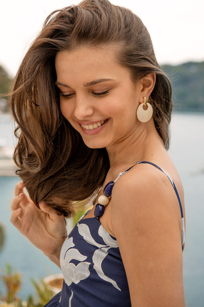 Nova Resin Drop Earrings in Gold with Cream Swirl campaign on model side