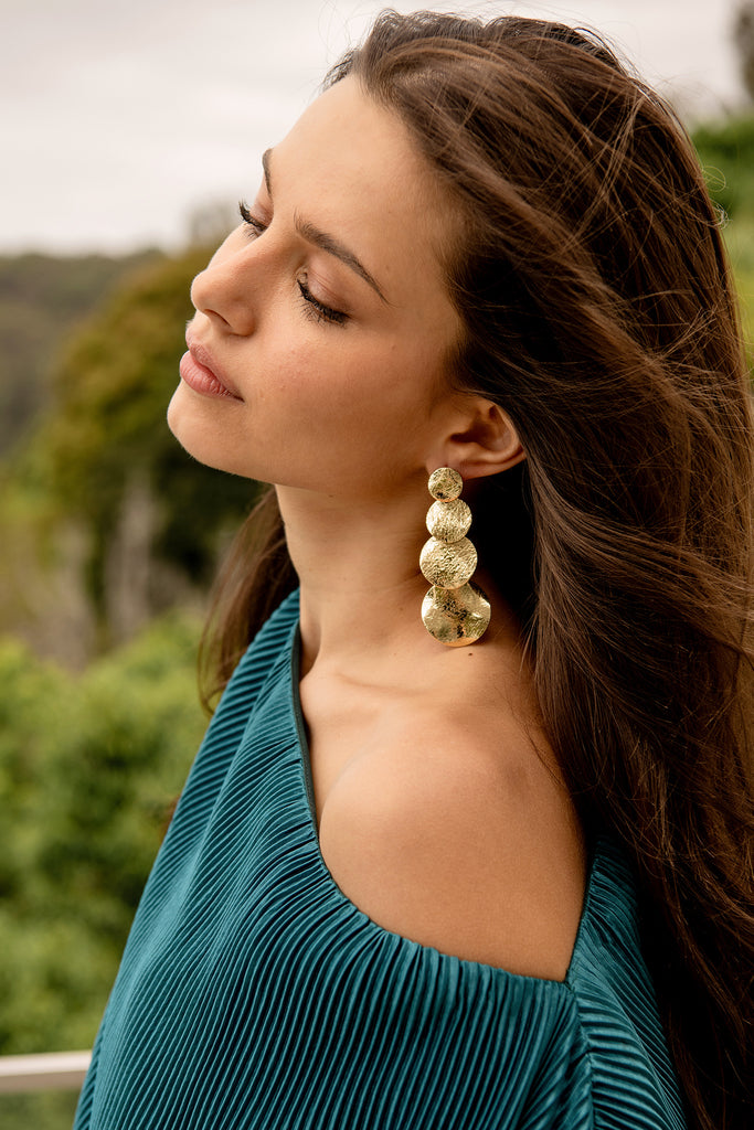 Alma Drop Earrings in Gold Textured campaign on model side